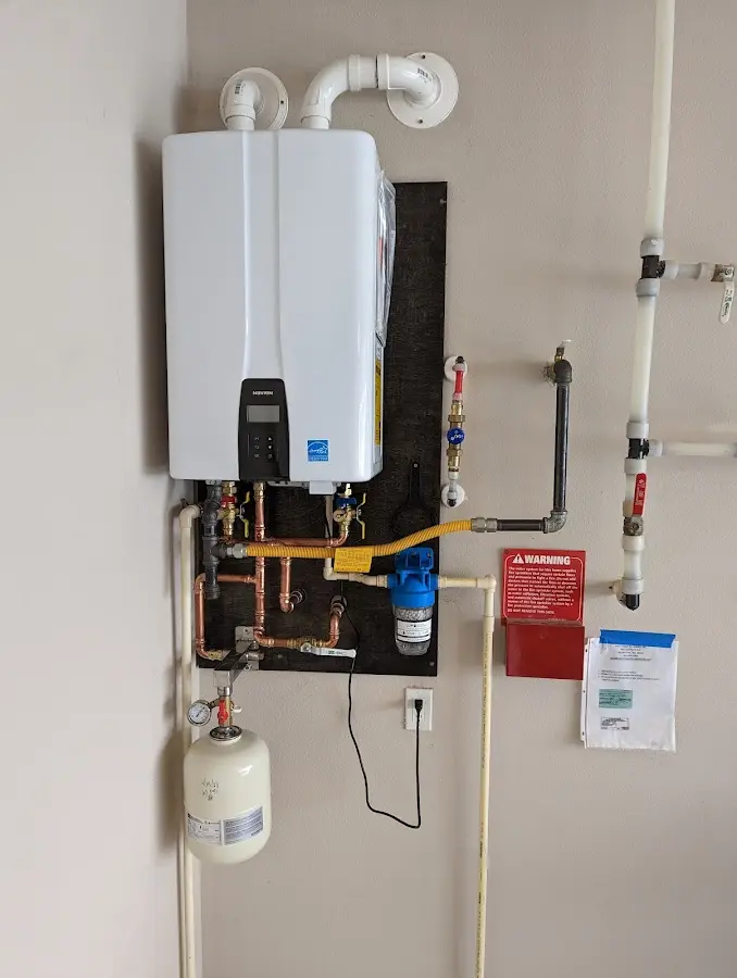 Professional plumber installing copper piping in a Port Huron home